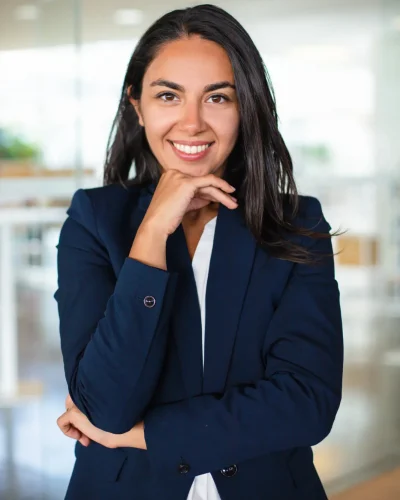 happy-businesswoman-with-hand-chin-jpg-e1708167471649.webp